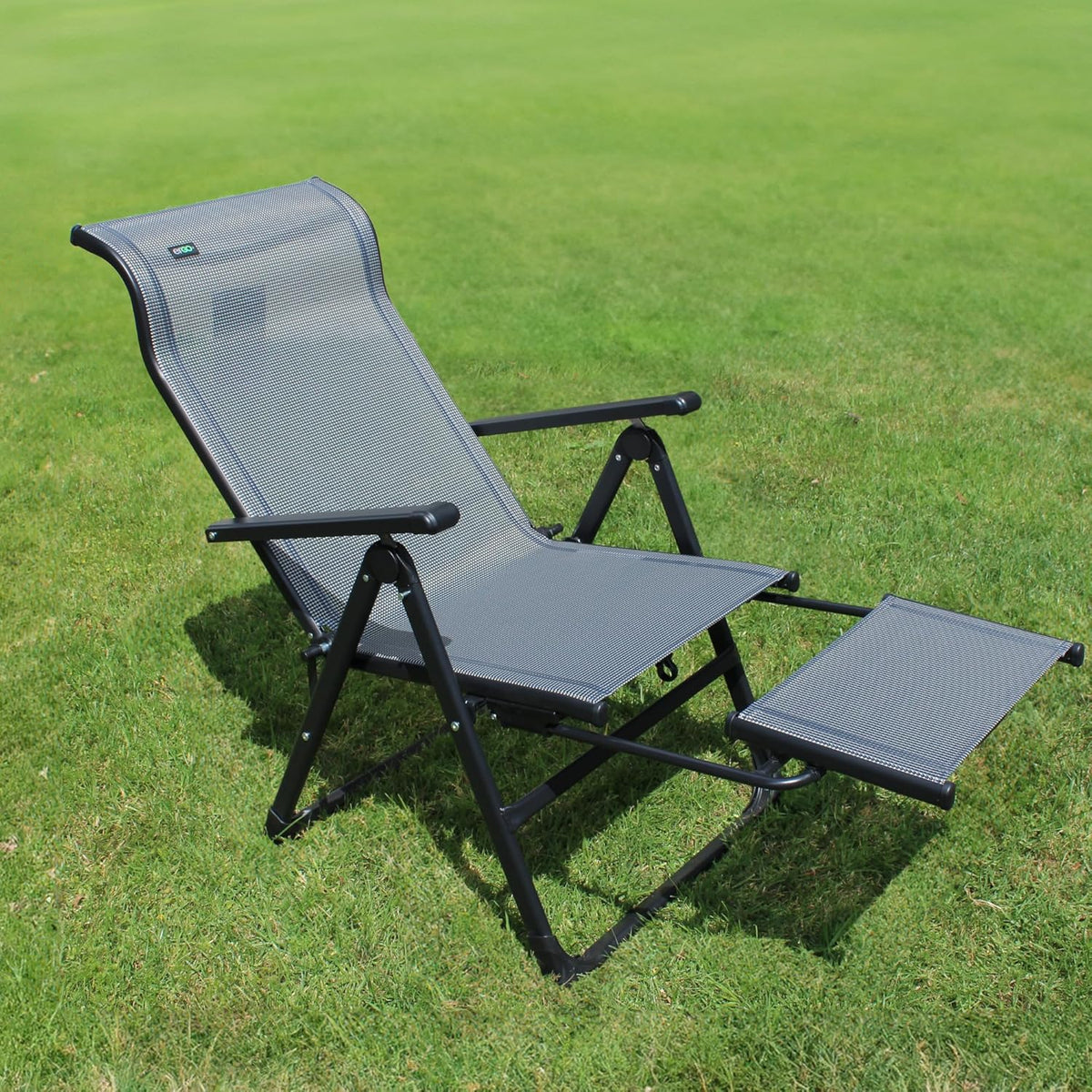Caravan Sports Ergo Plus chair reclined outdoors with the footrest extended